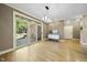 Bright dining room with modern lighting fixture and sliding glass doors leading to a deck at 6000 Canadero Dr, Raleigh, NC 27612