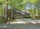 A charming brick home showing the driveway, and an attached two car garage at 6000 Canadero Dr, Raleigh, NC 27612