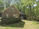 Aerial view of a brick home with a screened porch and large backyard surrounded by mature trees at 6000 Canadero Dr, Raleigh, NC 27612