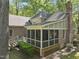 High angle view of a brick home featuring a screened-in porch and beautiful outdoor living space at 6000 Canadero Dr, Raleigh, NC 27612