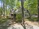 Charming two-story home featuring brick accents, a covered porch, and surrounded by mature trees at 6000 Canadero Dr, Raleigh, NC 27612