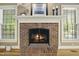 Close up of living room fireplace with decorative mantel and windows at 6000 Canadero Dr, Raleigh, NC 27612