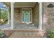 Welcoming front porch with classic brickwork, a decorative lantern, and a charming blue front door at 6000 Canadero Dr, Raleigh, NC 27612