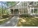 Charming covered front porch with brick accents, classic lighting, and a welcoming blue front door at 6000 Canadero Dr, Raleigh, NC 27612