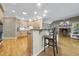 Bright kitchen with stainless appliances and breakfast bar overlooking the living area at 6000 Canadero Dr, Raleigh, NC 27612