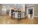Breakfast bar featuring stone counters with wooden stools in this gourmet kitchen at 6000 Canadero Dr, Raleigh, NC 27612