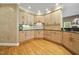 Light-filled kitchen with an abundance of natural wood cabinets and black countertops at 6000 Canadero Dr, Raleigh, NC 27612