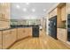 Modern kitchen with updated appliances and a view of the open living space at 6000 Canadero Dr, Raleigh, NC 27612