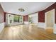 Bright living room with hardwood floors, large windows, and view to formal dining at 6000 Canadero Dr, Raleigh, NC 27612