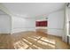 Spacious living room with hardwood floors, crown molding, and a view into an adjacent room at 6000 Canadero Dr, Raleigh, NC 27612
