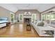 Vaulted living room with fireplace, hardwood floors, and large windows for natural light at 6000 Canadero Dr, Raleigh, NC 27612