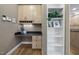 This office features custom cabinets, a black granite countertop, a built in desk, and a set of shelves at 6000 Canadero Dr, Raleigh, NC 27612