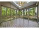 Screened-in porch with wood floors, a ceiling fan and views of the backyard at 6000 Canadero Dr, Raleigh, NC 27612