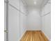 Walk in closet with adjustable shelving and wooden floors at 6000 Canadero Dr, Raleigh, NC 27612