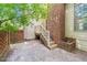 Brick-paved patio with a wooden staircase and access to a back entrance, providing a cozy outdoor space at 6000 Tenter Banks Sq, Raleigh, NC 27609