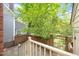 Private back patio featuring a brick privacy wall, lush trees and greenery, and easy access to the home's entrance at 6000 Tenter Banks Sq, Raleigh, NC 27609