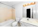 Bright bathroom with tub and shower, a large mirror, and a white toilet at 6000 Tenter Banks Sq, Raleigh, NC 27609