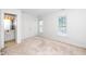 Bright bedroom features a double closet, two windows, and carpet flooring at 6000 Tenter Banks Sq, Raleigh, NC 27609