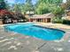Large community pool featuring a spacious patio area, comfortable seating, and lush surrounding greenery at 6000 Tenter Banks Sq, Raleigh, NC 27609