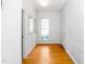 A bright and welcoming hallway with hardwood floors and a window at 6000 Tenter Banks Sq, Raleigh, NC 27609
