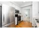 A bright kitchen featuring white cabinets, stainless steel appliances, and hardwood floors at 6000 Tenter Banks Sq, Raleigh, NC 27609