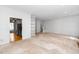 Open-concept living space with built-in shelving and easy access to kitchen and staircase at 6000 Tenter Banks Sq, Raleigh, NC 27609