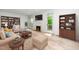 Inviting living room featuring a fireplace, built-in bookshelves, and large windows for ample natural light at 6000 Tenter Banks Sq, Raleigh, NC 27609