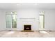Bright living area with a white-painted fireplace, window, and door at 6000 Tenter Banks Sq, Raleigh, NC 27609