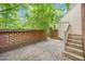 A brick patio area with a brick wall, stairs, a small yard, and a gate at 6000 Tenter Banks Sq, Raleigh, NC 27609