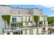 Rooftop balcony with beautiful seating, potted plants, and building vines at 601 W Rosemary St # 905, Chapel Hill, NC 27516