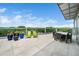 Rooftop balcony with outdoor furniture overlooking lush greenery and clear sky at 601 W Rosemary St # 905, Chapel Hill, NC 27516