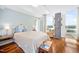 Bright bedroom with hardwood floors, a decorative bed frame, and large windows with a view at 601 W Rosemary St # 905, Chapel Hill, NC 27516