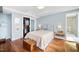 Cozy bedroom features hardwood floors, a decorative headboard, and a spacious walk-in closet at 601 W Rosemary St # 905, Chapel Hill, NC 27516