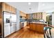 Bright kitchen with stainless steel appliances, wooden cabinets and island at 601 W Rosemary St # 905, Chapel Hill, NC 27516