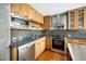 Well-lit kitchen with granite countertops, stainless steel appliances, and sleek wooden cabinetry at 601 W Rosemary St # 905, Chapel Hill, NC 27516
