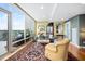 Light filled living room with hardwood floors, area rug, comfortable seating, and large windows overlooking the terrace at 601 W Rosemary St # 905, Chapel Hill, NC 27516