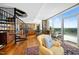 Open concept living room with hardwood floors, dining, kitchen and large windows overlooking the view at 601 W Rosemary St # 905, Chapel Hill, NC 27516