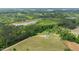 Aerial view of a home on a large lot near a lake surrounded by trees at 675 Anderson Creek Rd, Henderson, NC 27537