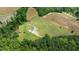 Aerial view of a house on a large lot surrounded by lush trees and open fields at 675 Anderson Creek Rd, Henderson, NC 27537