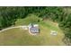 Expansive property featuring a charming farmhouse with a metal roof surrounded by lush greenery at 675 Anderson Creek Rd, Henderson, NC 27537