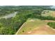 Aerial view of a lovely home and property surrounded by lush trees and lake at 675 Anderson Creek Rd, Henderson, NC 27537
