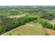 Aerial view of a home on a large lot near a lake surrounded by trees at 675 Anderson Creek Rd, Henderson, NC 27537