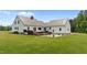Spacious backyard with a wooden deck, a concrete patio and plenty of room for outdoor activities at 675 Anderson Creek Rd, Henderson, NC 27537