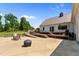Spacious concrete patio in backyard featuring a wooden deck, perfect for outdoor entertaining and relaxation at 675 Anderson Creek Rd, Henderson, NC 27537