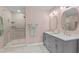 Stylish bathroom featuring a dual vanity, modern lighting, and walk-in shower at 675 Anderson Creek Rd, Henderson, NC 27537