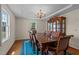 Elegant dining room with hardwood floors, a large wooden table, and a decorative chandelier at 675 Anderson Creek Rd, Henderson, NC 27537