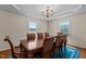 Elegant dining room featuring a hardwood table and a decorative chandelier under coffered ceilings at 675 Anderson Creek Rd, Henderson, NC 27537