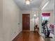 Inviting entryway with hardwood floors, traditional lighting, and a view into an adjacent room at 675 Anderson Creek Rd, Henderson, NC 27537