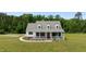 Charming two-story home with a metal roof, a front porch, and lush landscaping, perfect for curb appeal at 675 Anderson Creek Rd, Henderson, NC 27537