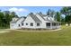 Inviting two-story farmhouse with a metal roof, manicured landscaping, and a charming front porch at 675 Anderson Creek Rd, Henderson, NC 27537